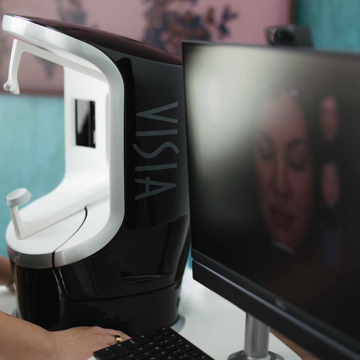 Close-up of a woman’s face and hand.