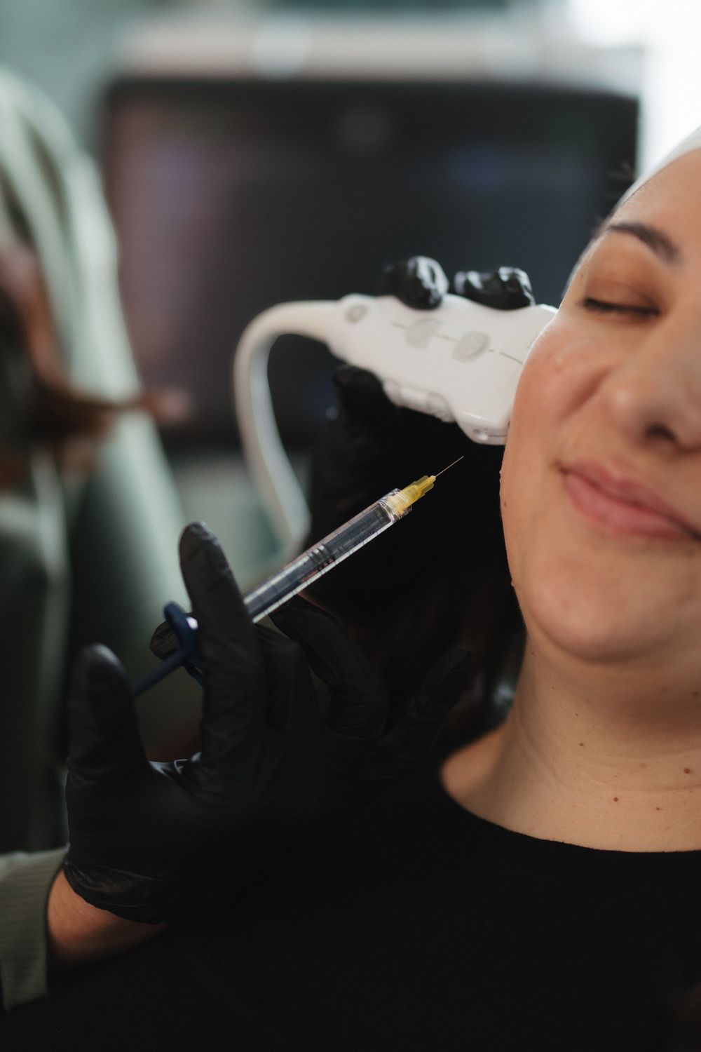 Smiling older woman with elegant hairstyle and accessories.